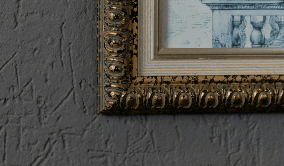 close up of a painting and frame on a wall