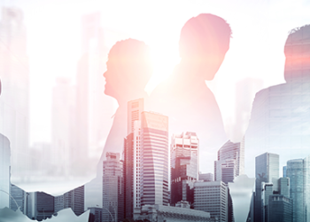 Transparent figures shaking hands in front of a cityscape