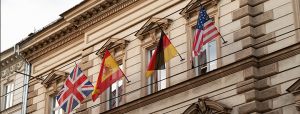 Flags of spain, germany, USA and the UK on the side of a building