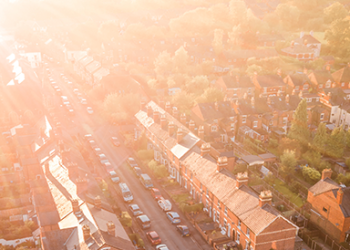 Sunshine rays reaching across rows of houses